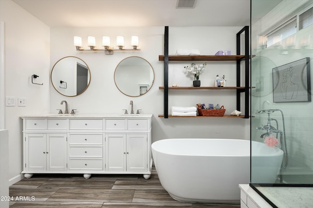 bathroom featuring hardwood / wood-style floors, vanity, and shower with separate bathtub