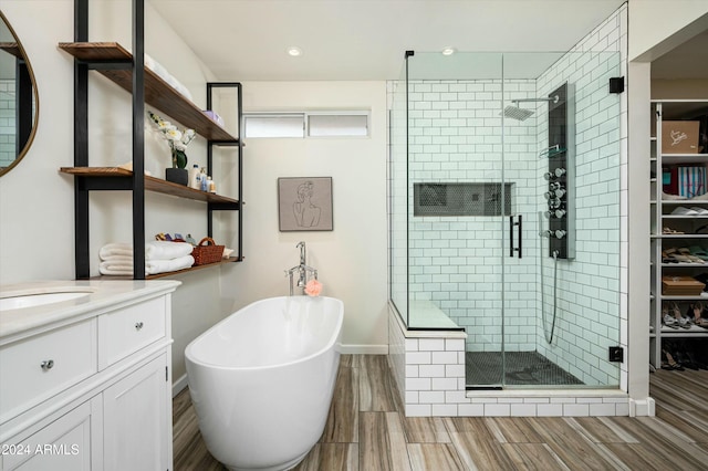 bathroom with vanity and separate shower and tub