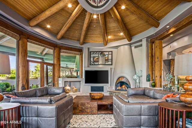 living room featuring a large fireplace, beamed ceiling, wooden ceiling, and high vaulted ceiling