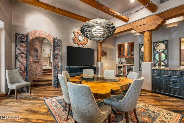 dining room with beamed ceiling, dark hardwood / wood-style flooring, and beverage cooler