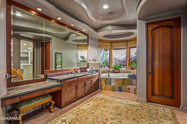 bathroom with vanity and a relaxing tiled tub