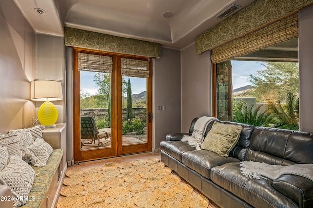 doorway to outside with plenty of natural light, a mountain view, and french doors