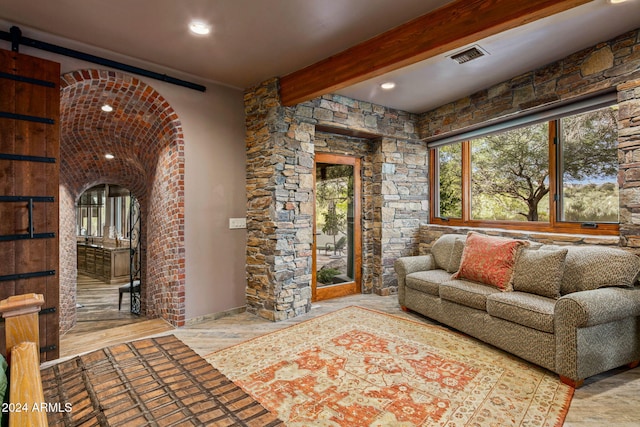 unfurnished living room featuring beam ceiling