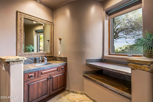 bathroom featuring a wealth of natural light and vanity