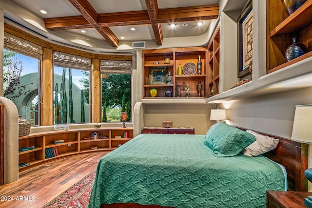 bedroom with beamed ceiling, hardwood / wood-style floors, and coffered ceiling