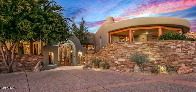 pueblo-style home featuring french doors