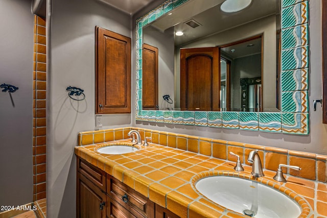 bathroom featuring tasteful backsplash and vanity