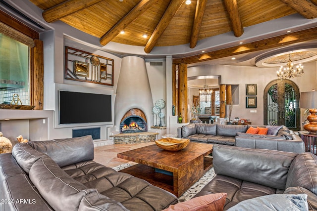 living room with a fireplace, lofted ceiling with beams, a chandelier, and wood ceiling