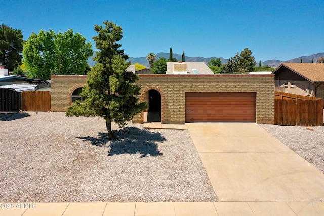 view of front of property featuring a garage and a mountain view