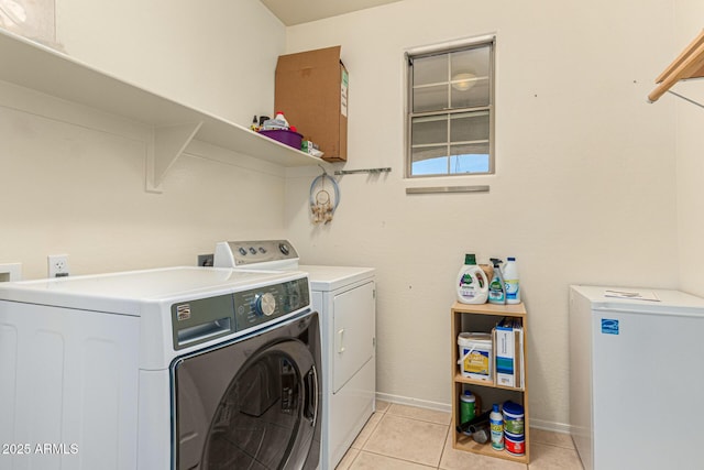 washroom with washing machine and dryer and light tile patterned floors