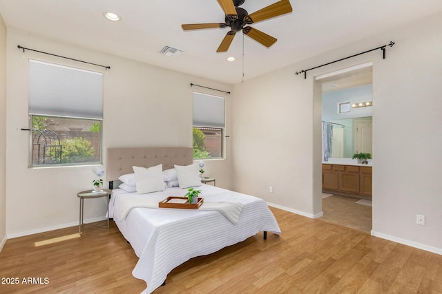 bedroom featuring ensuite bathroom, ceiling fan, and light hardwood / wood-style floors