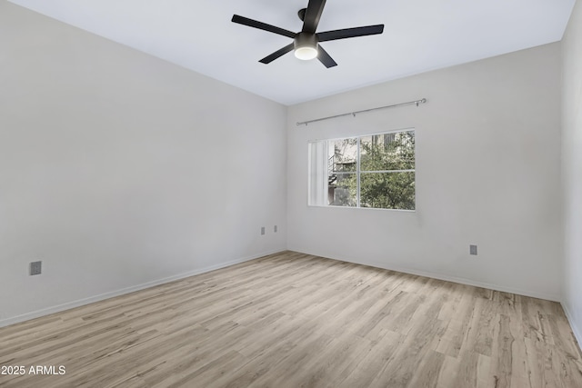 spare room with ceiling fan and light hardwood / wood-style flooring