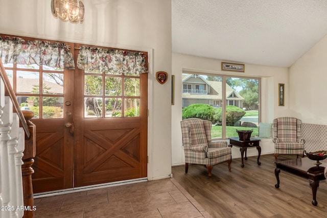 4601 E Sunnyside Ln, Phoenix, AZ 85032 - foyer with lofted ceiling, wood finished floors, a textured ceiling, and a chandelier