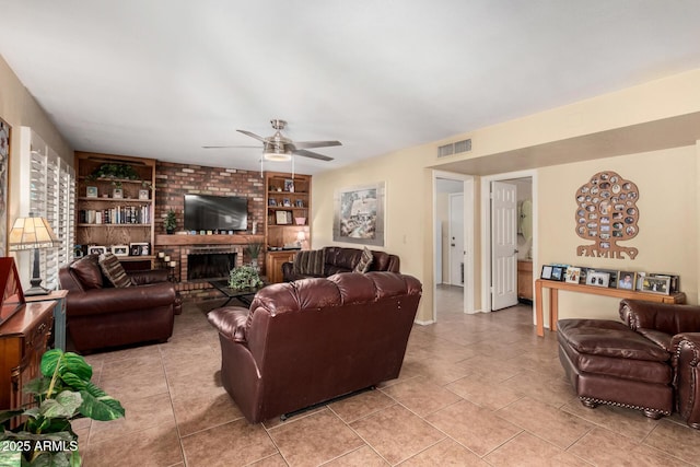 4601 E Sunnyside Ln, Phoenix, AZ 85032 - living room featuring a ceiling fan, built in features, a brick fireplace, and light tile patterned floors