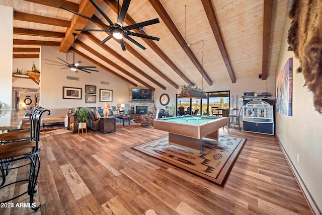 playroom with visible vents, beamed ceiling, a stone fireplace, wood finished floors, and billiards