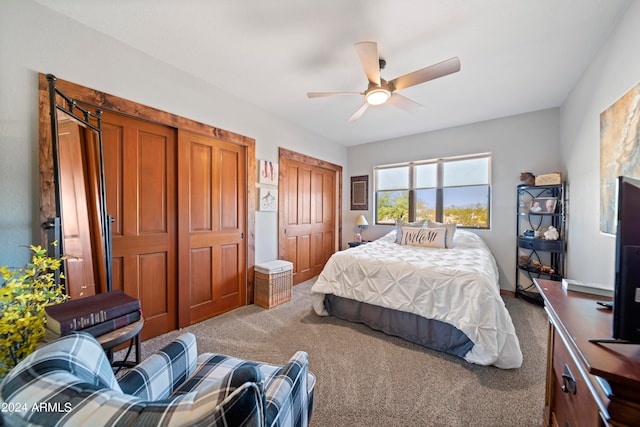 bedroom with multiple closets, carpet, and ceiling fan