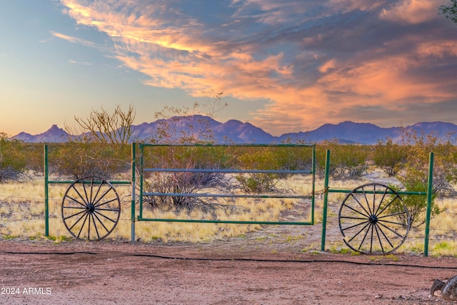 gate at dusk with a mountain view