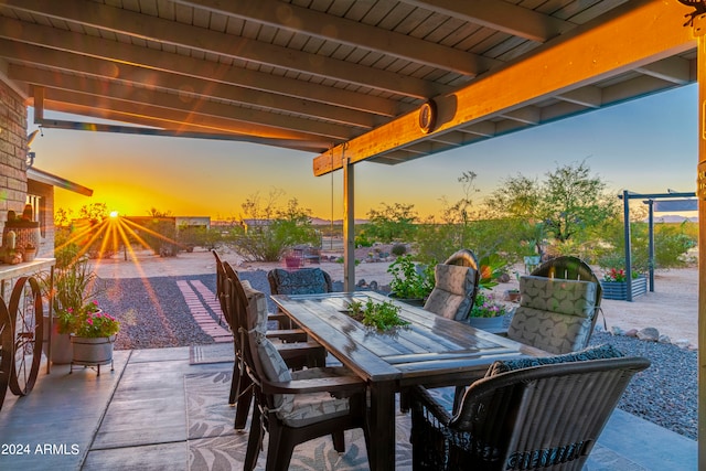 patio terrace at dusk featuring outdoor dining space