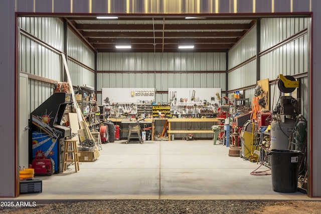 garage featuring a workshop area and metal wall