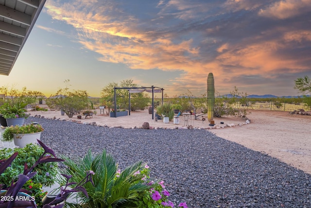 yard at dusk with a patio area