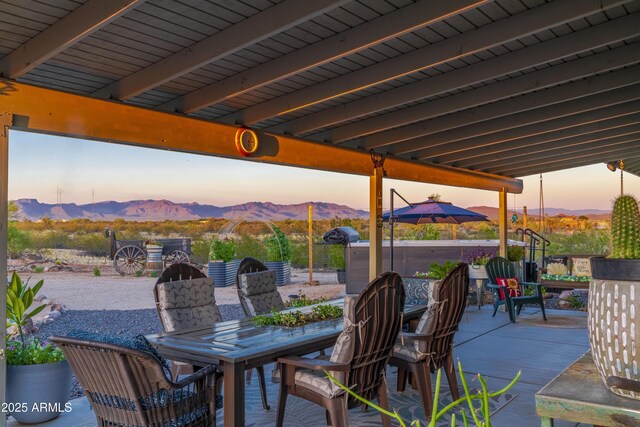 view of patio / terrace featuring outdoor dining space and a mountain view