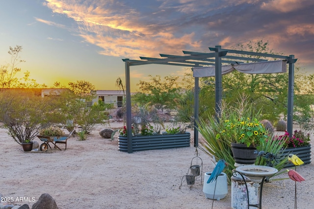 exterior space with a vegetable garden and a pergola