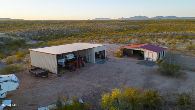 aerial view at dusk featuring a mountain view