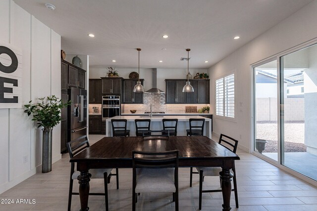 dining area featuring light hardwood / wood-style flooring and sink