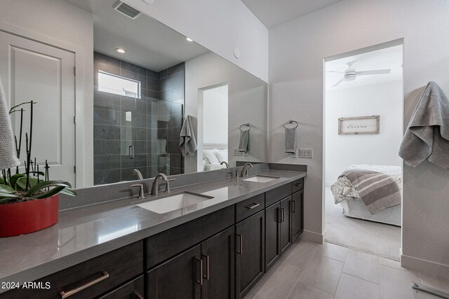 bathroom with a shower with door and tile patterned floors