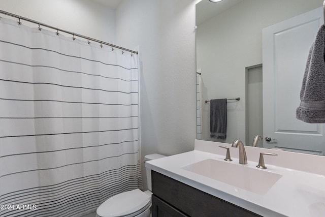 bathroom with vanity, toilet, and a shower with curtain