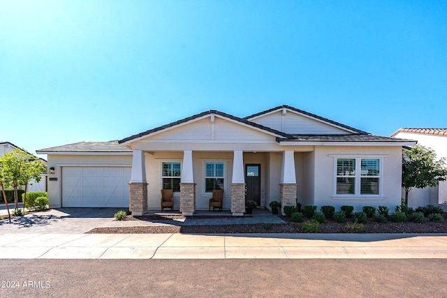 view of front of house featuring covered porch and a garage