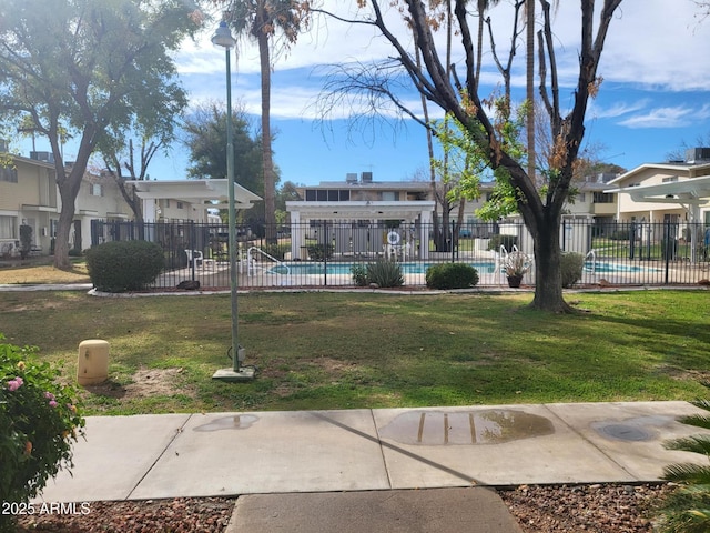 view of home's community with a yard and a swimming pool