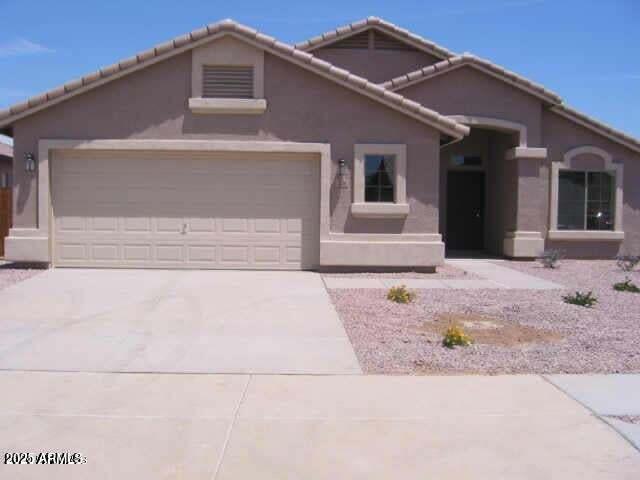 7716 W Pueblo Ave, Phoenix, AZ 85043 - view of front of house featuring an attached garage, driveway, stucco siding, and a tile roof