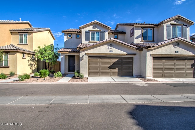 mediterranean / spanish-style home featuring a garage