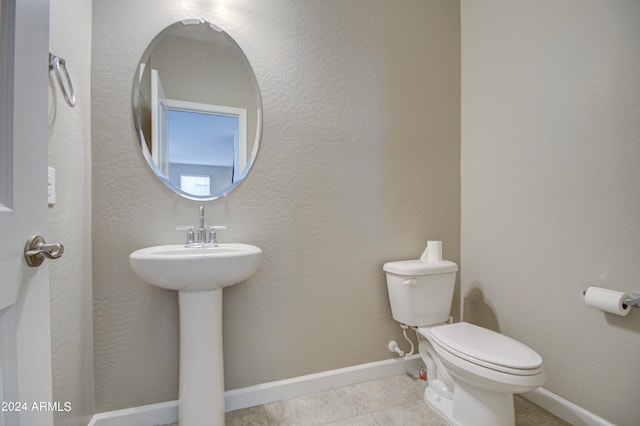 bathroom featuring toilet and tile patterned floors