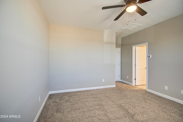 empty room featuring lofted ceiling, ceiling fan, and light carpet