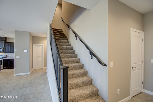 stairs featuring tile patterned flooring