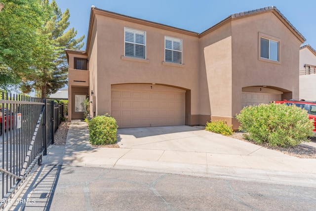 4202 N 21st St Unit 1, Phoenix, AZ 85016 - view of front of house with an attached garage, stucco siding, and driveway