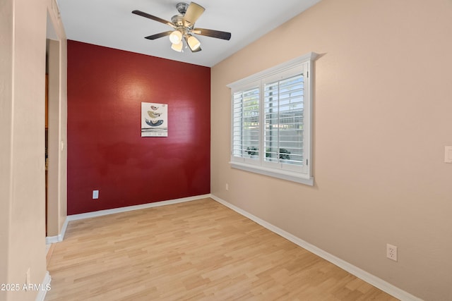 4202 N 21st St Unit 1, Phoenix, AZ 85016 - empty room with an accent wall, wood finished floors, and ceiling fan