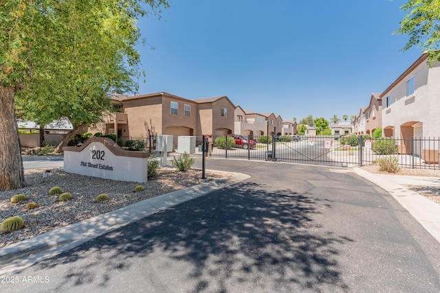 4202 N 21st St Unit 1, Phoenix, AZ 85016 - view of asphalt road with a residential view, a gate, a gated entry, and curbs