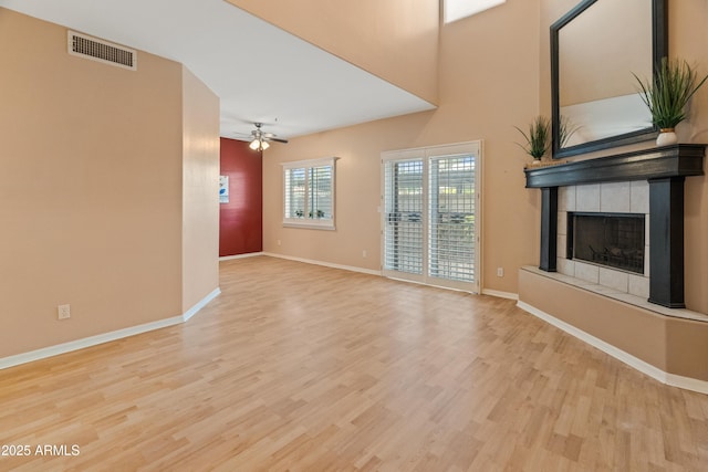 4202 N 21st St Unit 1, Phoenix, AZ 85016 - unfurnished living room with wood finished floors, a fireplace with raised hearth, and ceiling fan