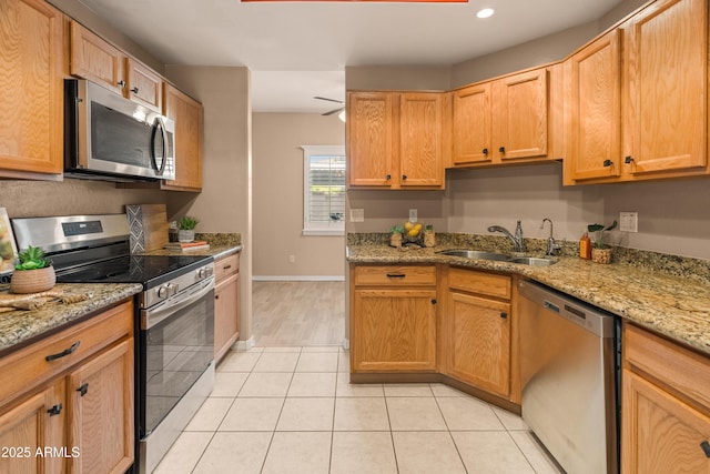 4202 N 21st St Unit 1, Phoenix, AZ 85016 - kitchen featuring appliances with stainless steel finishes, light tile patterned flooring, recessed lighting, and light stone counters