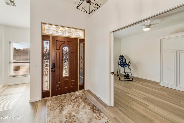 foyer with ceiling fan and light hardwood / wood-style floors