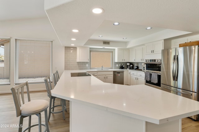 kitchen featuring white cabinetry, appliances with stainless steel finishes, sink, and backsplash