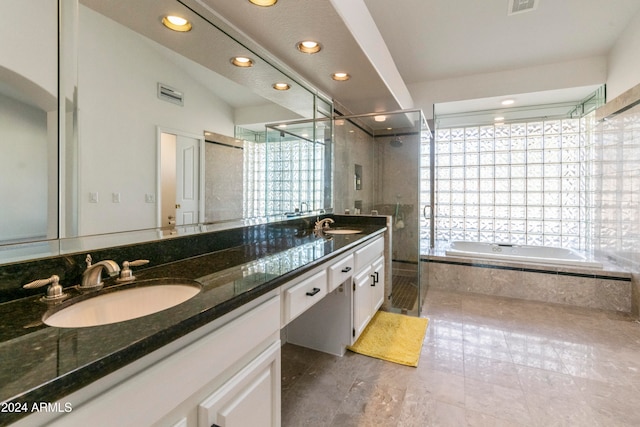 bathroom featuring vanity, independent shower and bath, and vaulted ceiling