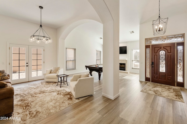 foyer entrance with pool table, light wood-type flooring, and french doors