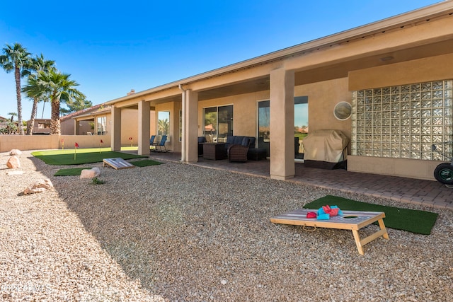 back of house featuring a patio and an outdoor living space