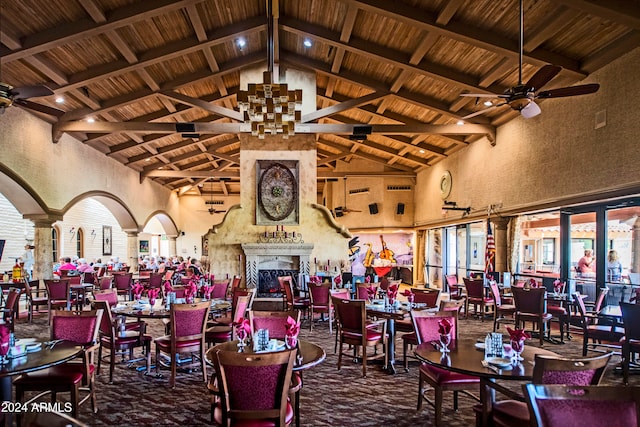 dining space featuring decorative columns, high vaulted ceiling, ceiling fan, and beam ceiling