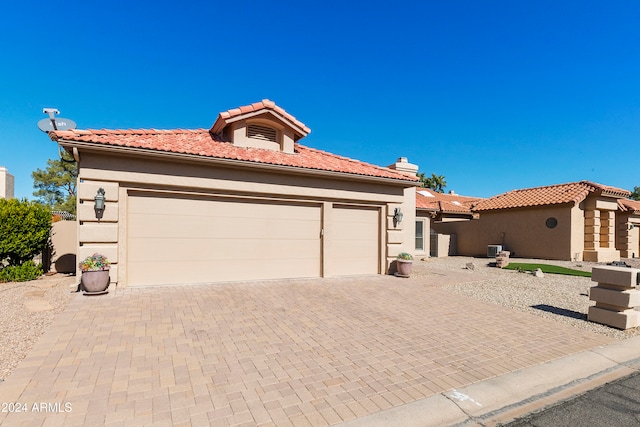 mediterranean / spanish-style home with a garage