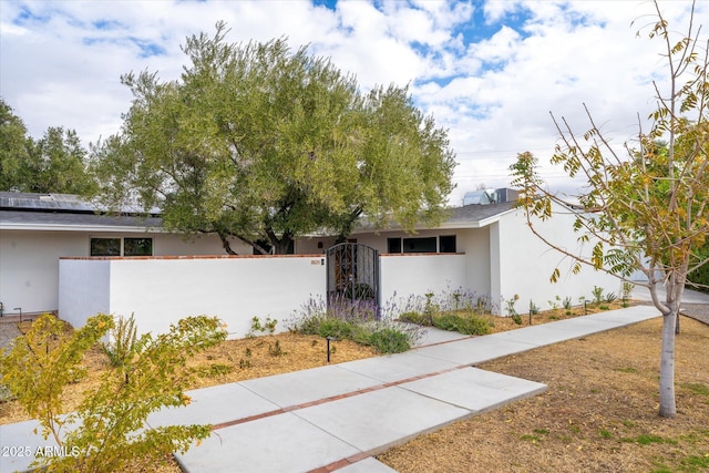 view of front of home featuring solar panels